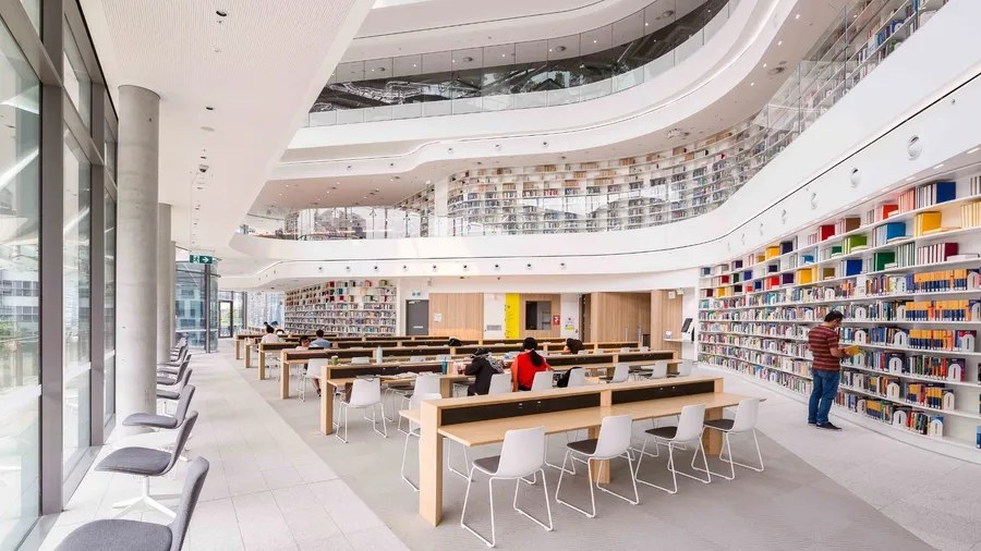 Rows of bookshelves in a bright, sunlit library