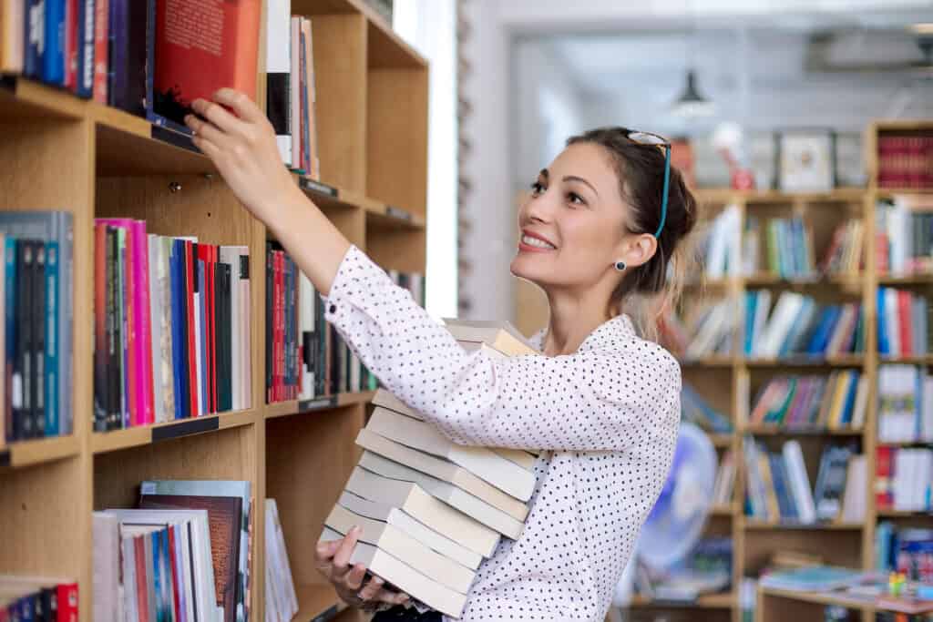 A librarian shelving books in a library