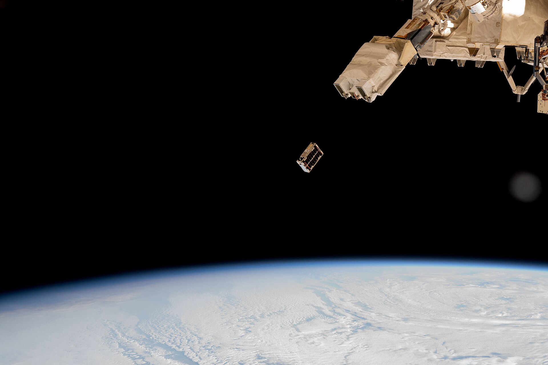 A CubeSat being deployed into Earth orbit