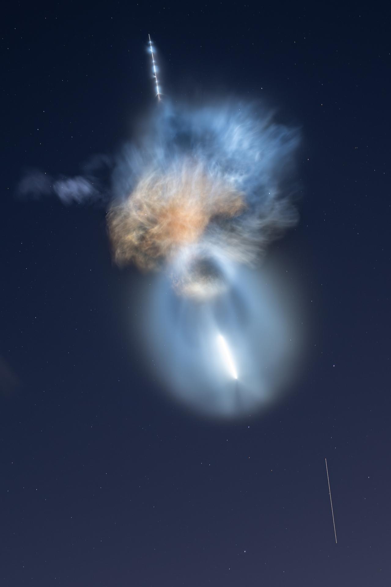 In a 15-second long exposure, the International Space Station is seen as a streak of light during the launch of NASA's SpaceX CRS-35 mission on Oct. 13, 2026