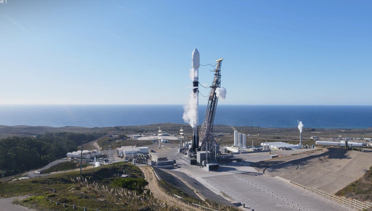 A SpaceX Falcon 9 rocket on Space Launch Complex 4-East at Vandenberg, with the Pacific Ocean in the background