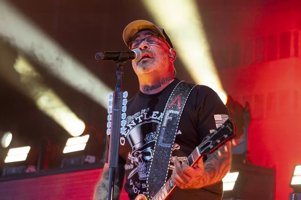 Aaron Lewis performs on stage with Staind