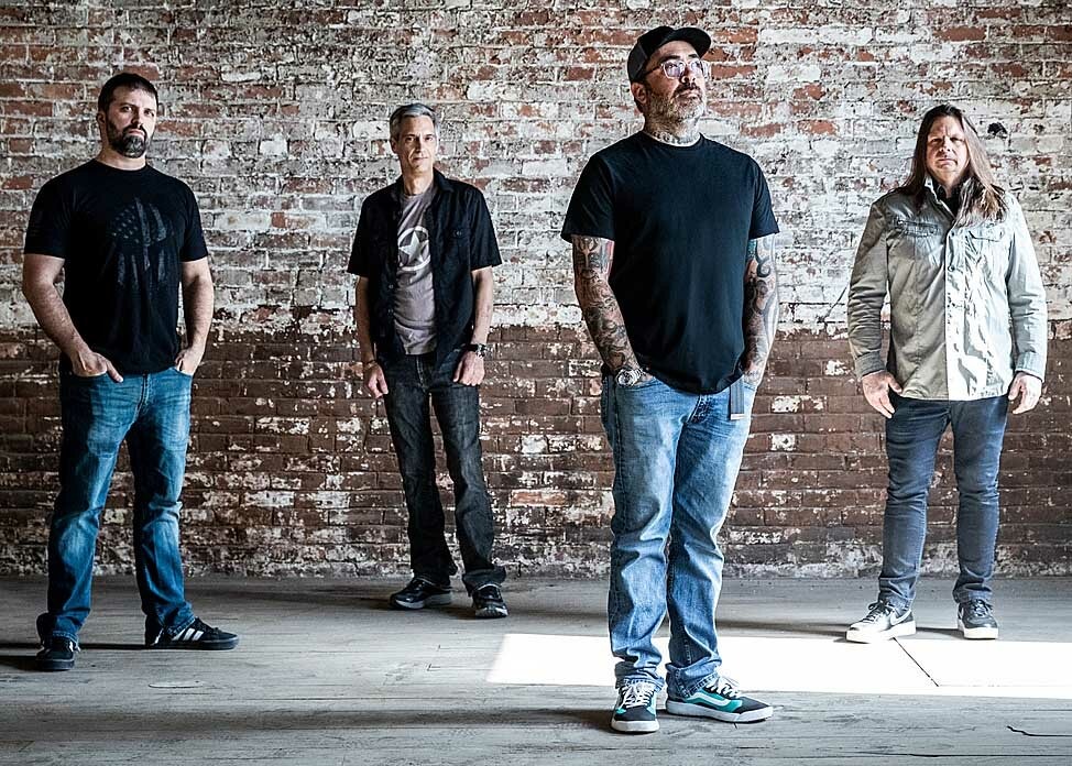 Staind band portrait against a brick wall