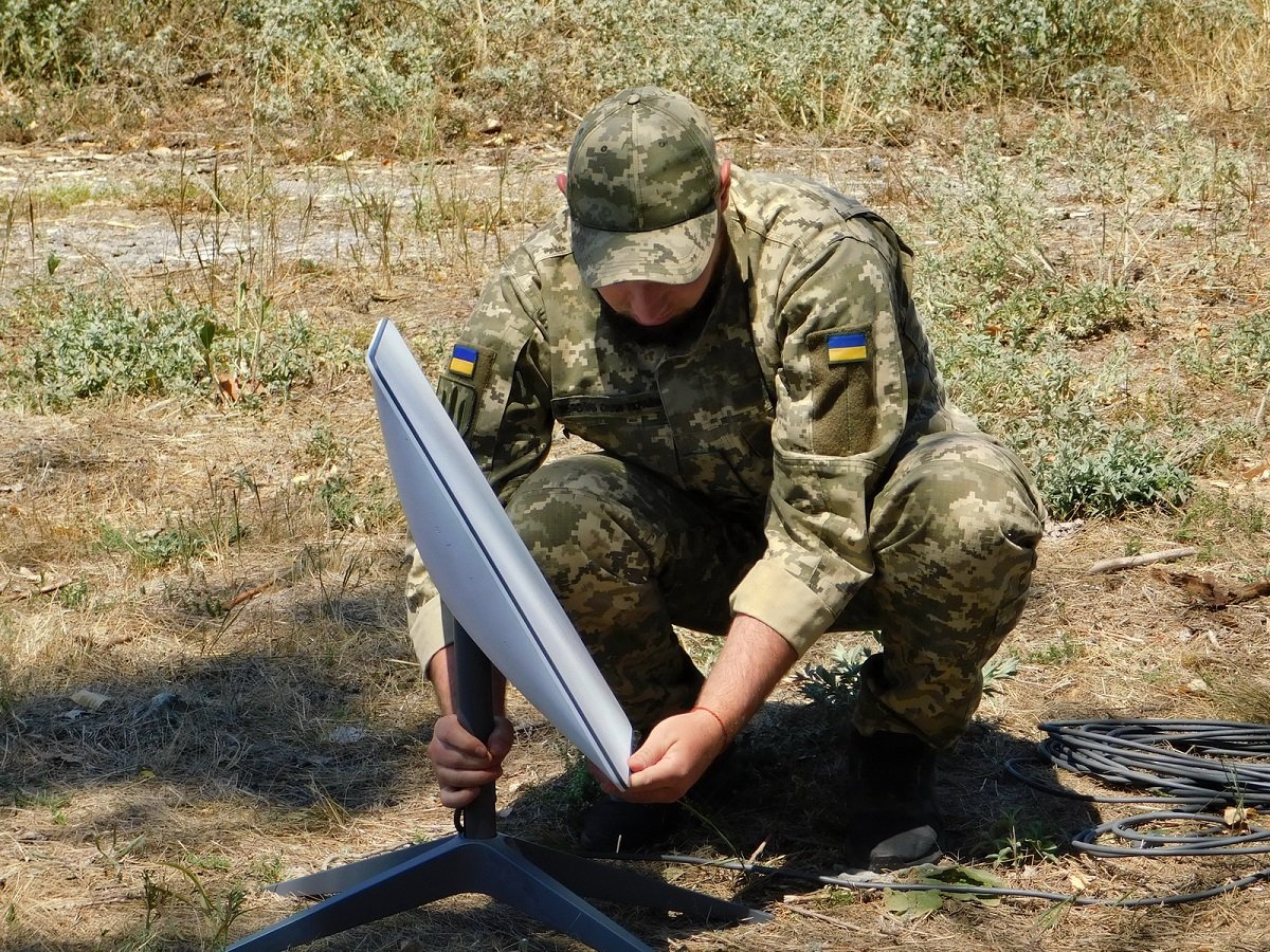 A Ukrainian serviceman setting up a Starlink terminal