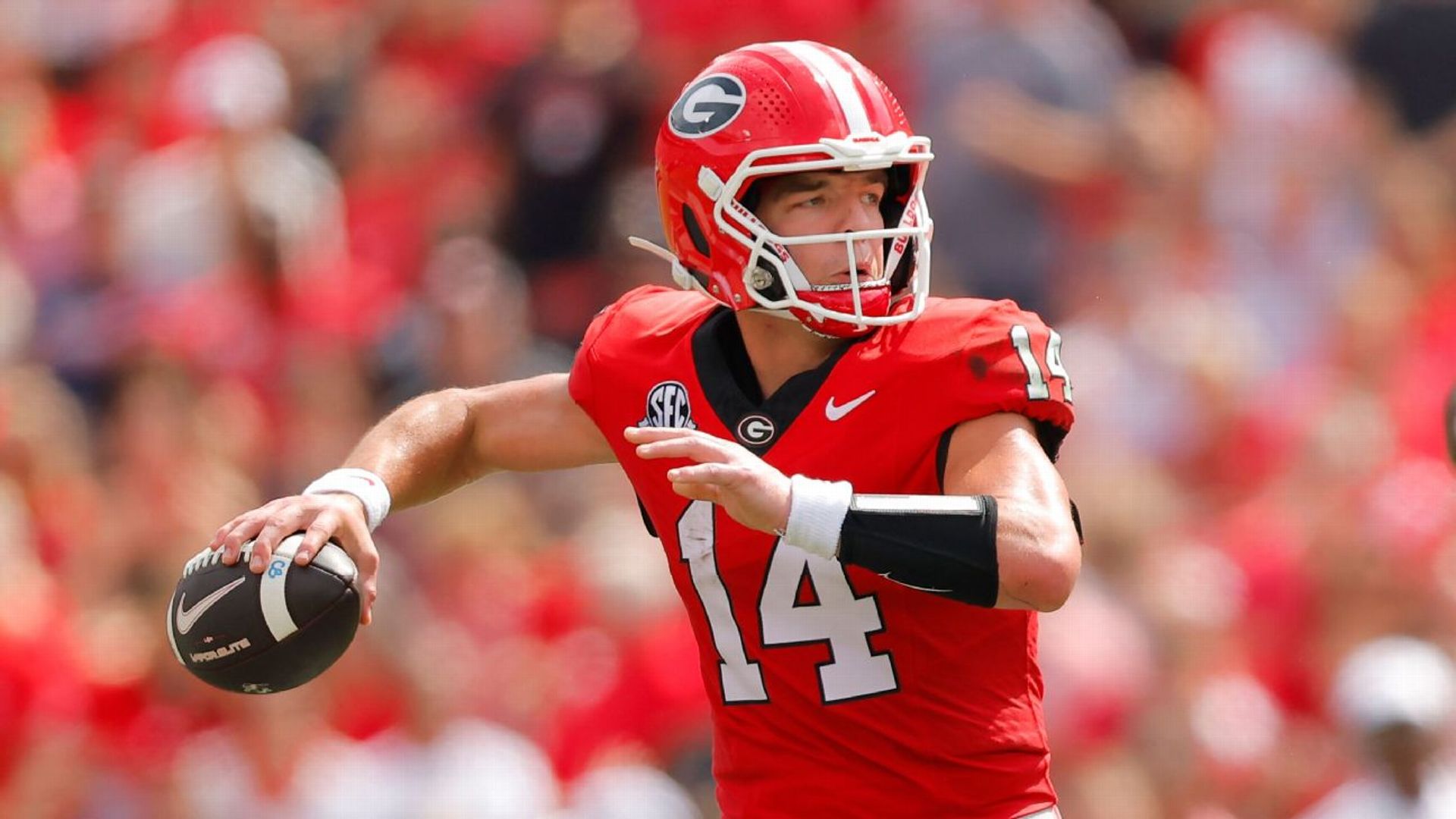 Georgia quarterback Gunner Stockton, wearing No. 14 in Georgia's red home uniform, throwing a pass during a 2026 home game at Sanford Stadium