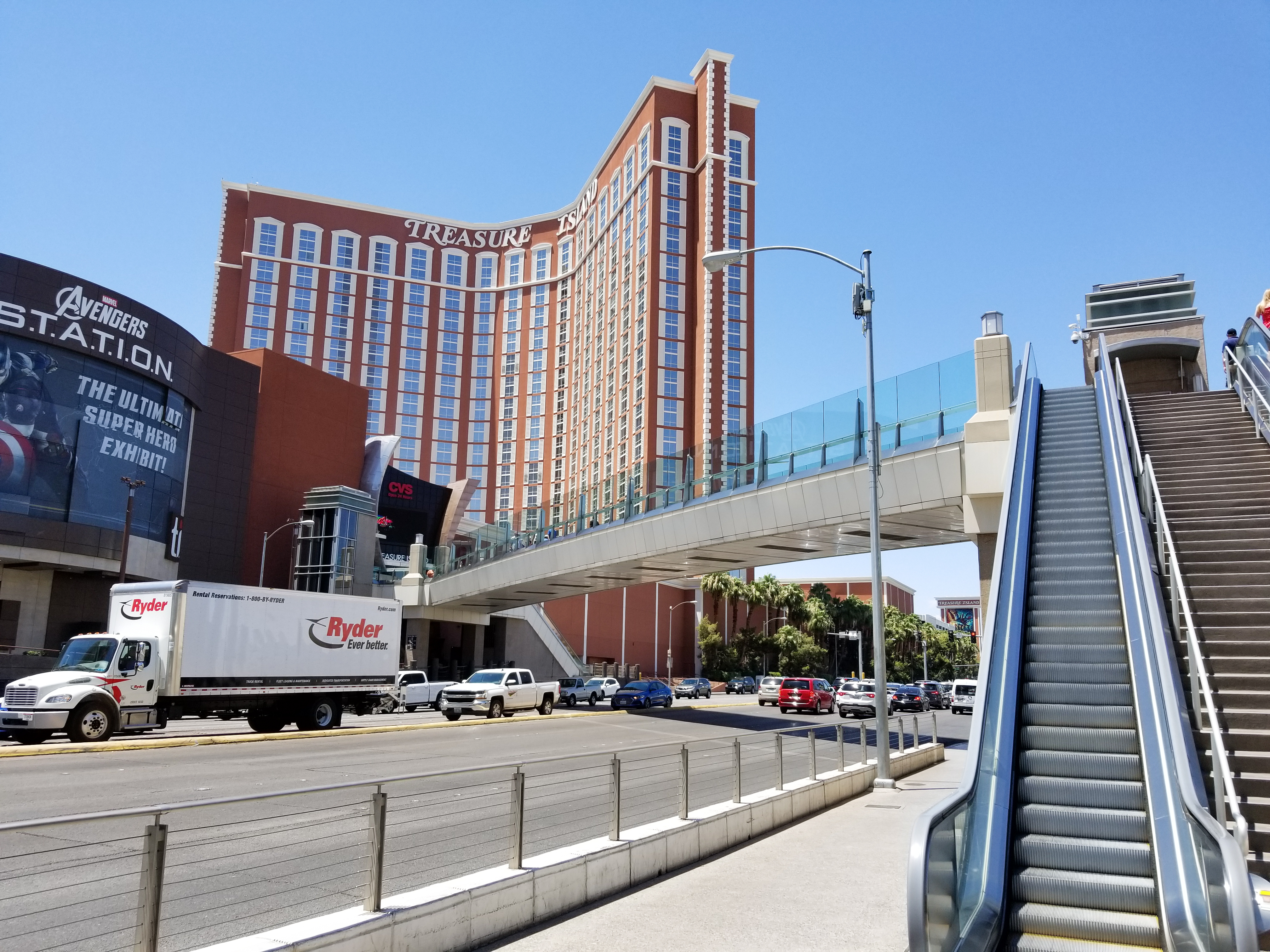 A pedestrian bridge crossing the Las Vegas Strip in bright daylight