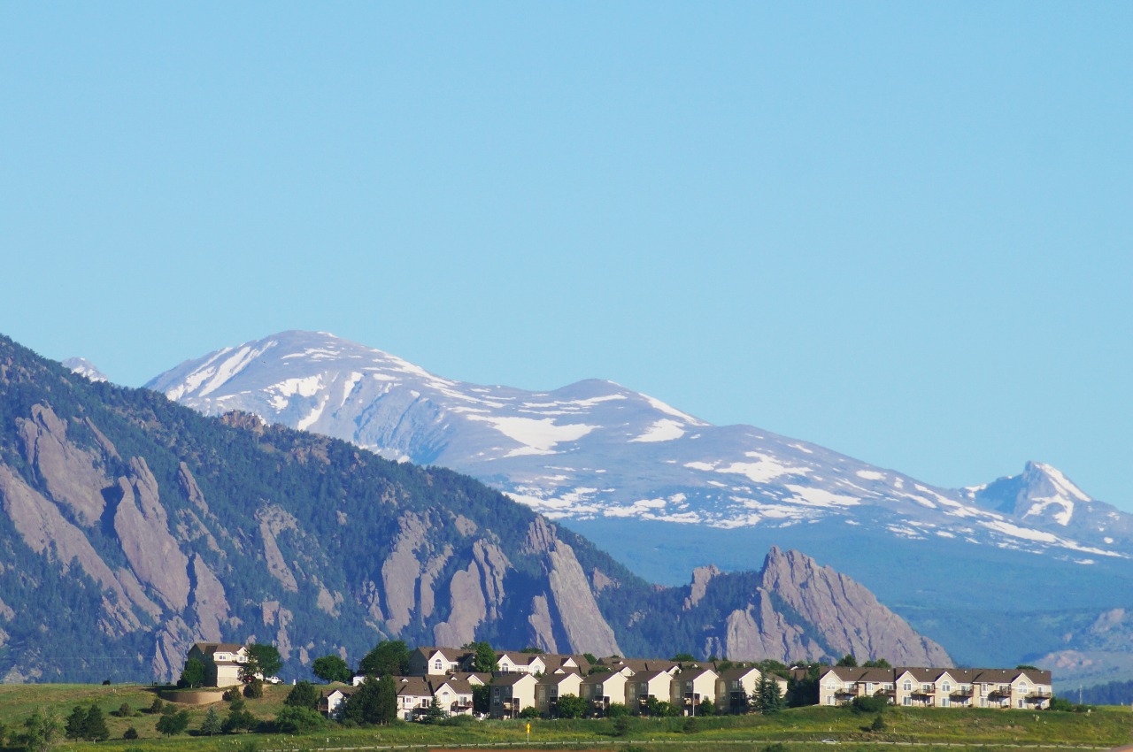 Boulder, Colorado, with the Flatirons rising behind the city on a bright day