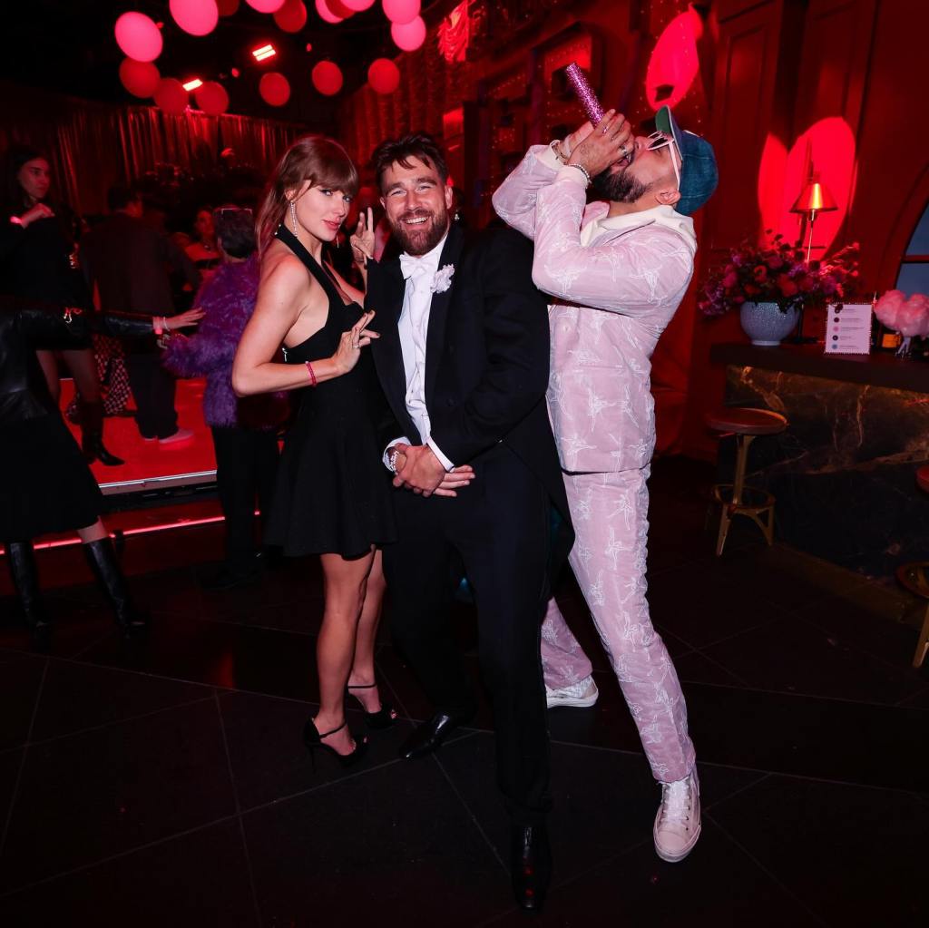 Taylor Swift and Travis Kelce posing for a photo at an event