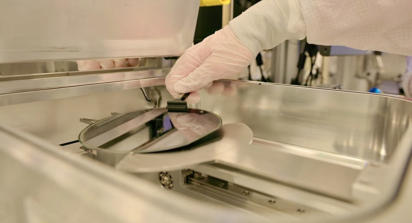 A researcher holding a silicon wafer in a semiconductor lab (file photo)