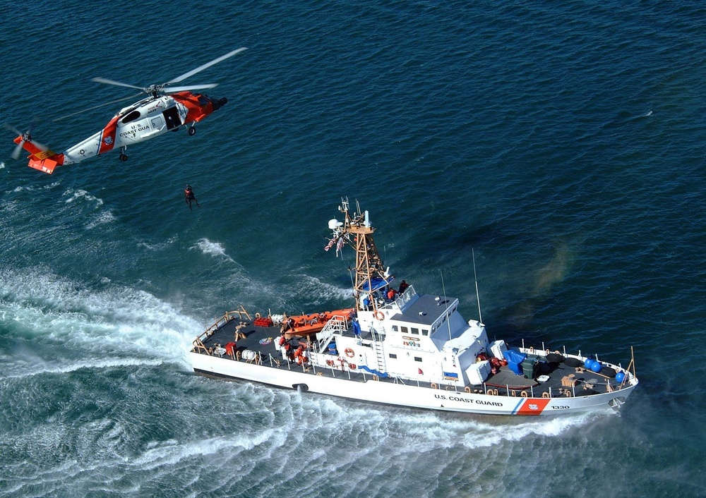 U.S. Coast Guard helicopter and cutter during a search