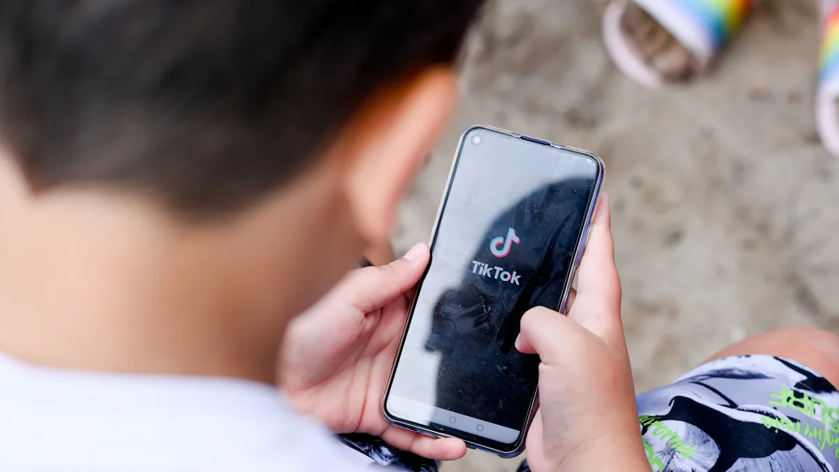 Close crop of a child holding a smartphone with TikTok open