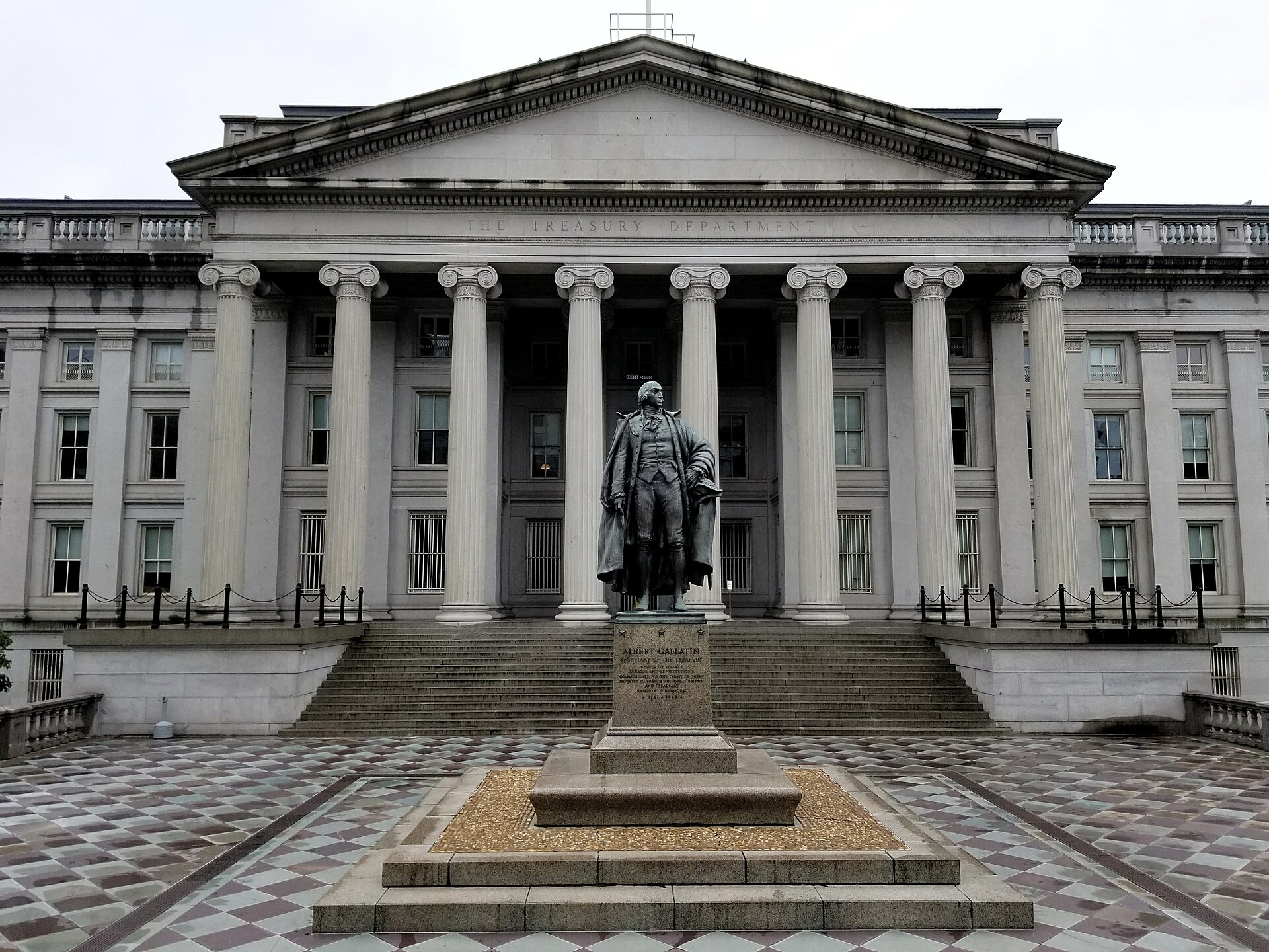 The U.S. Treasury Building and Albert Gallatin statue in Washington, D.C.