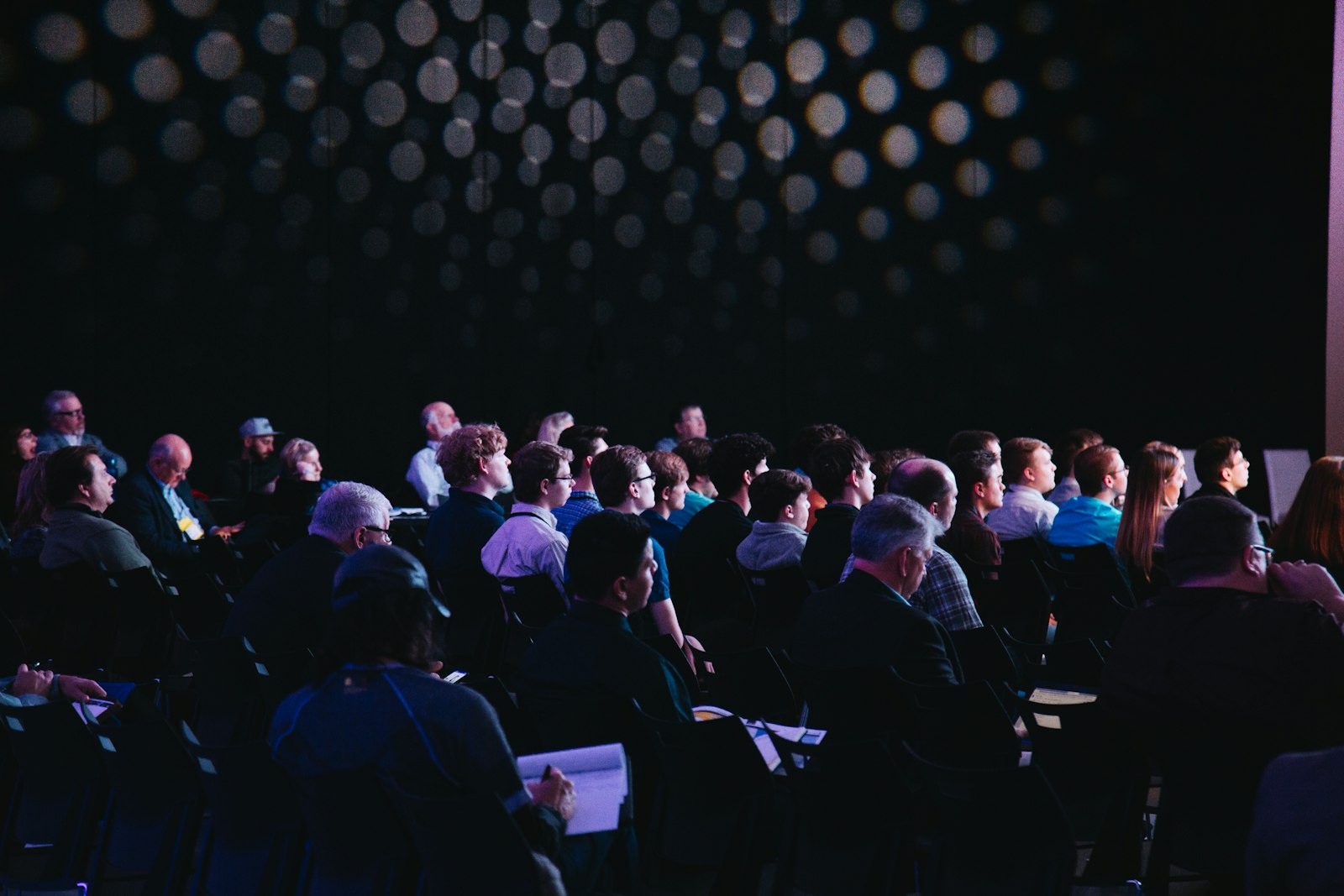 A large crowd gathered at a brightly lit indoor event
