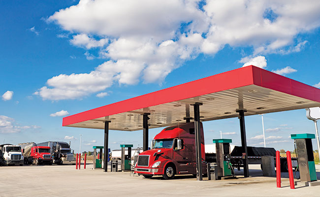 A semi truck fueling at a truck stop.