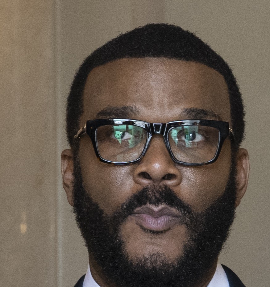 Tyler Perry in a suit and glasses, photographed at Arlington National Cemetery in November 2024