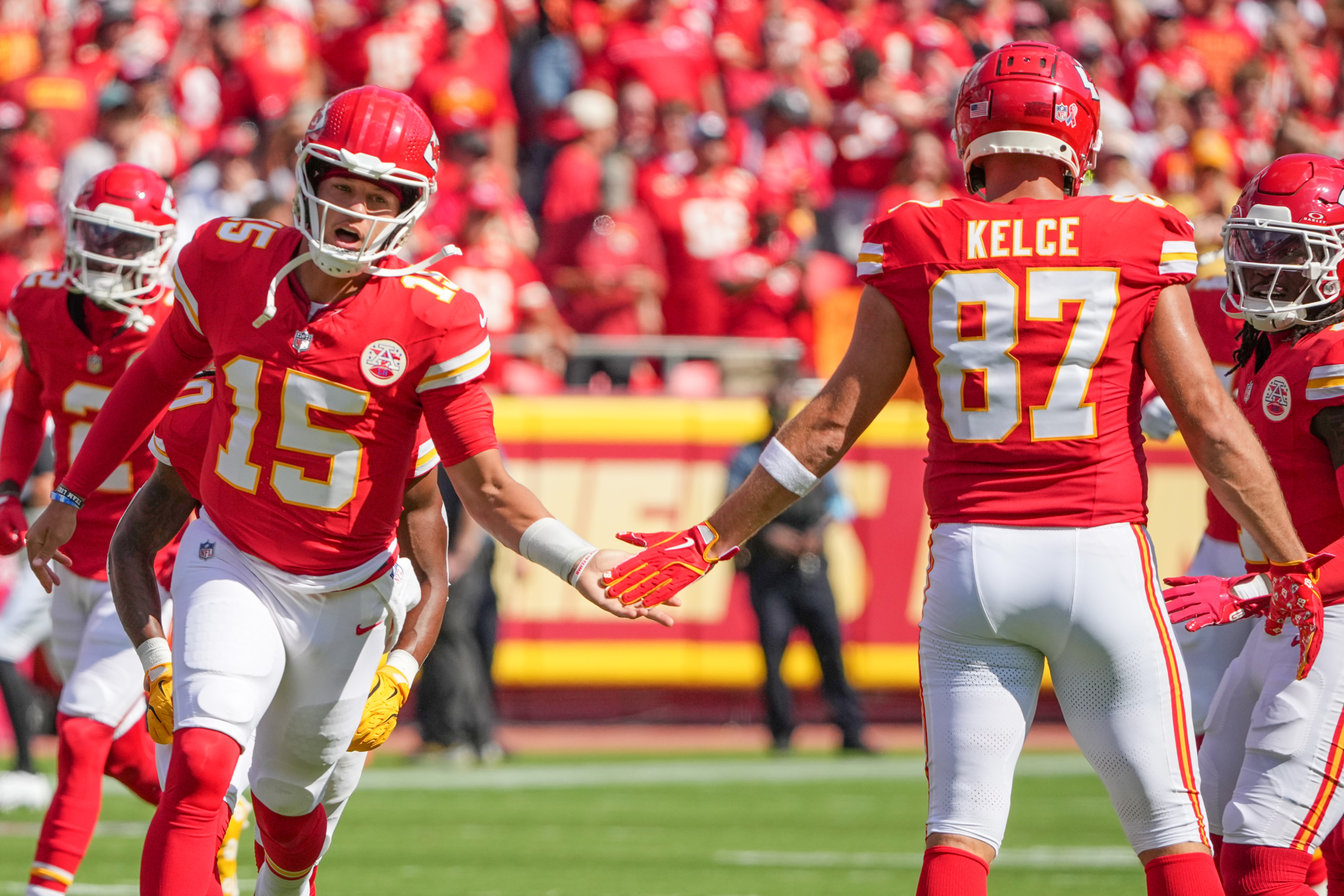 Patrick Mahomes (15) with Travis Kelce (87) in Chiefs red — Mahomes said a Hill reunion would be
