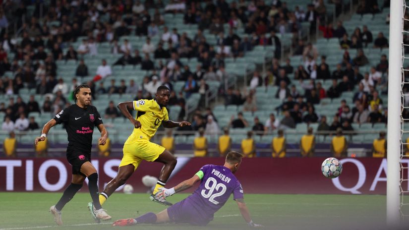 Serhou Guirassy shoots past Sabah goalkeeper Stas Pokatilov for Borussia Dortmund at Baku Olympic Stadium