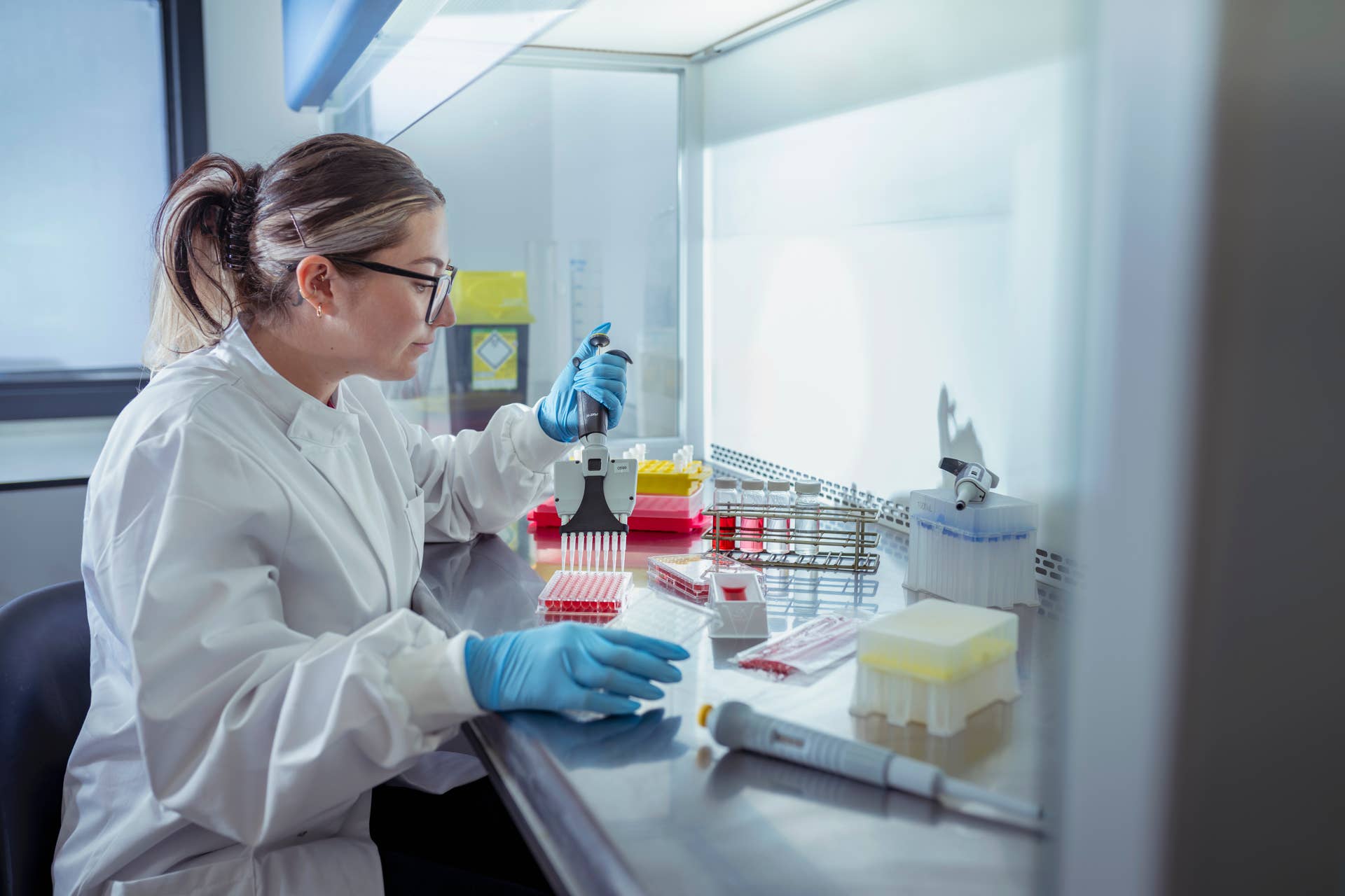 A scientist pipetting samples in a laboratory