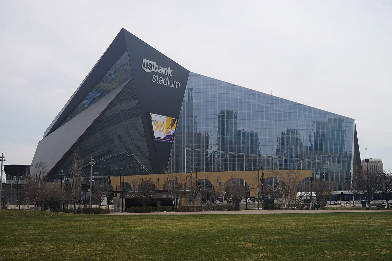 The interior of U.S. Bank Stadium in Minneapolis, brightly lit with the field and seating bowl visible