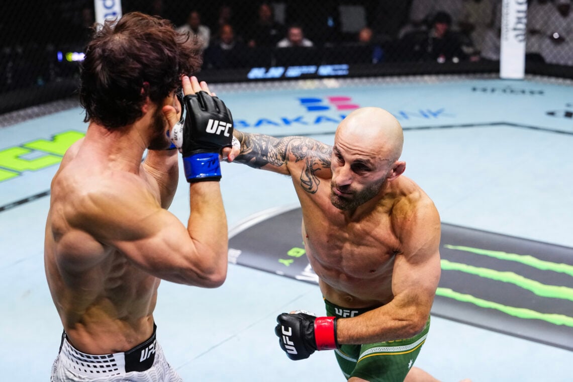 Alexander Volkanovski (green-and-gold shorts) drives a right hand into Movsar Evloev (white patterned shorts) inside the Octagon at Etihad Arena during the UFC 333 featherweight title fight on October 24, 2026