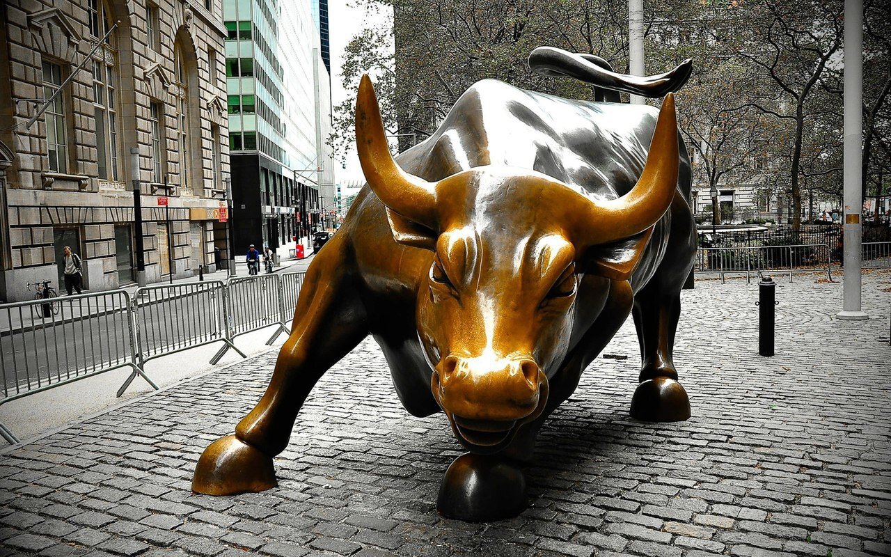 The Wall Street bull statue in daylight as stocks hit record highs.