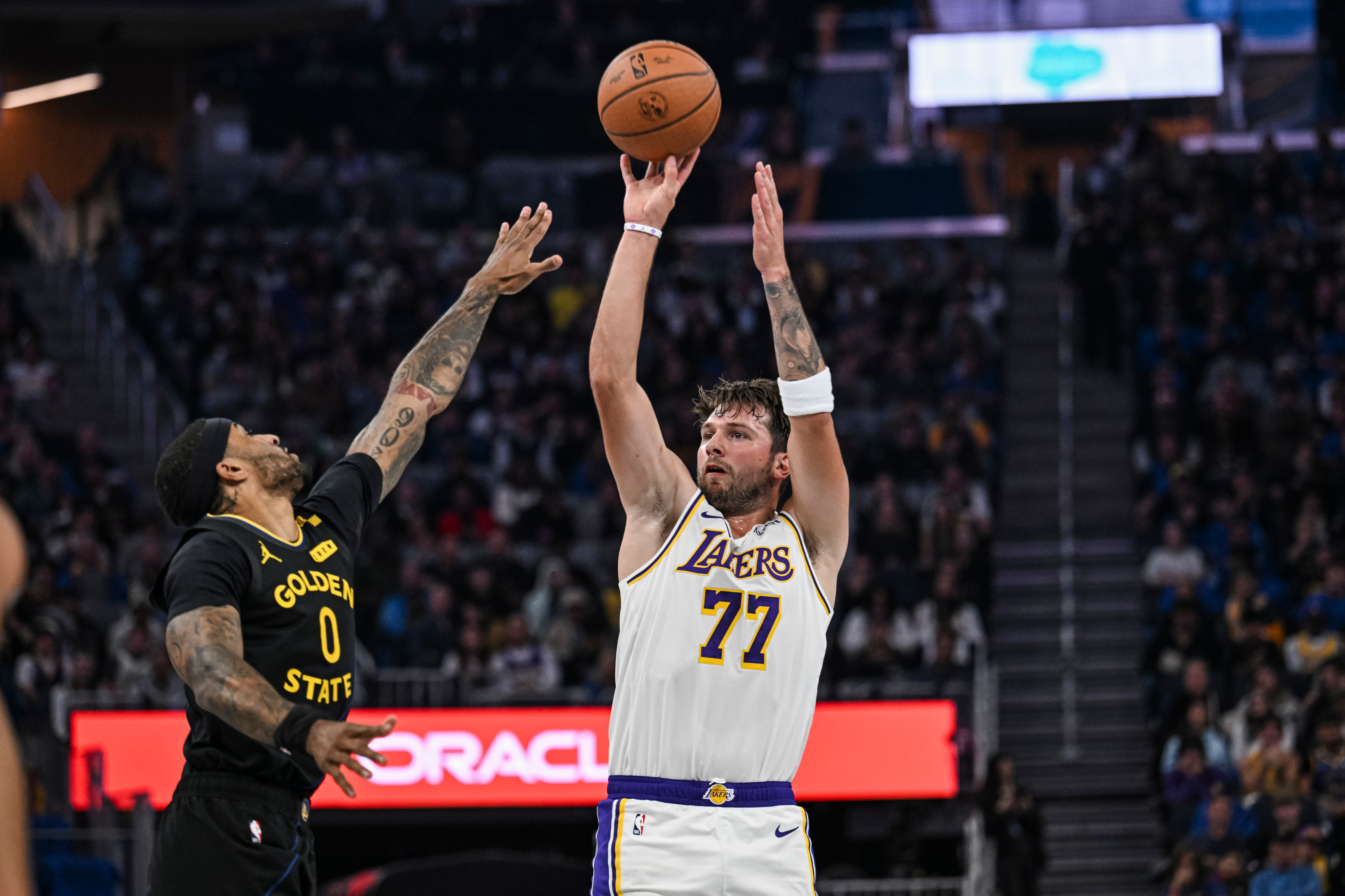 Los Angeles Lakers guard Luka Doncic (77) shoots over Golden State Warriors guard Gary Payton II (0) during an NBA Cup game, Friday, Oct. 30, 2026, in San Francisco (AP Photo/Justine Willard)