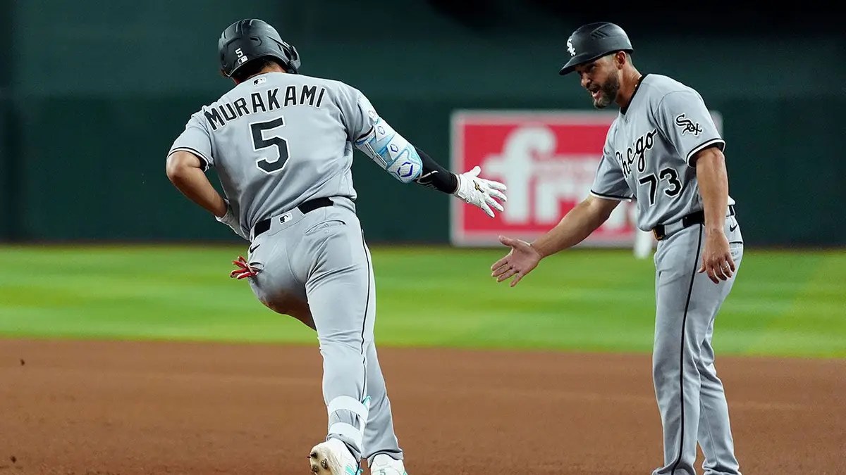 Munetaka Murakami of the White Sox celebrates a home run with third base coach José Leger