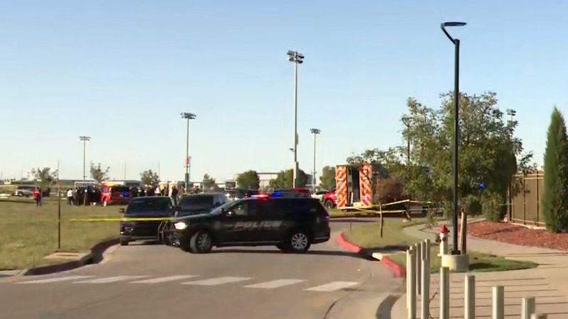 Police and emergency vehicles behind yellow tape at an entrance to Stryker Sports Complex in Wichita, Kansas, on Saturday