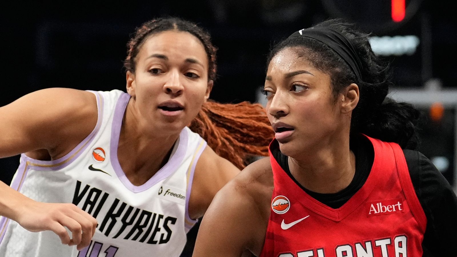 Angel Reese of the Atlanta Dream, in the red home uniform, works against Kiah Stokes of the Golden State Valkyries during Game 6 of the 2026 WNBA Finals at State Farm Arena