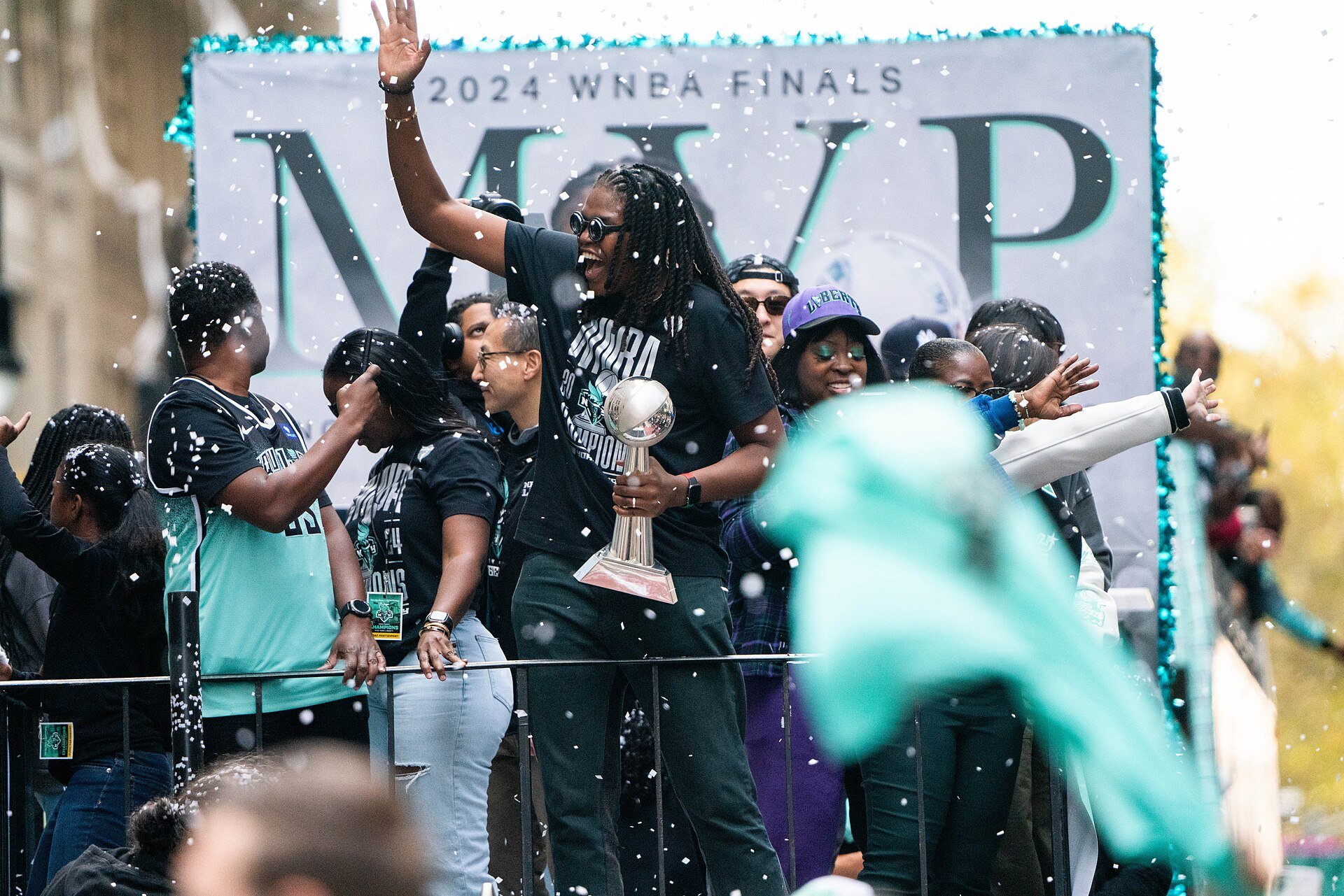 Jonquel Jones celebrates with the WNBA Finals MVP trophy at the New York Liberty championship parade