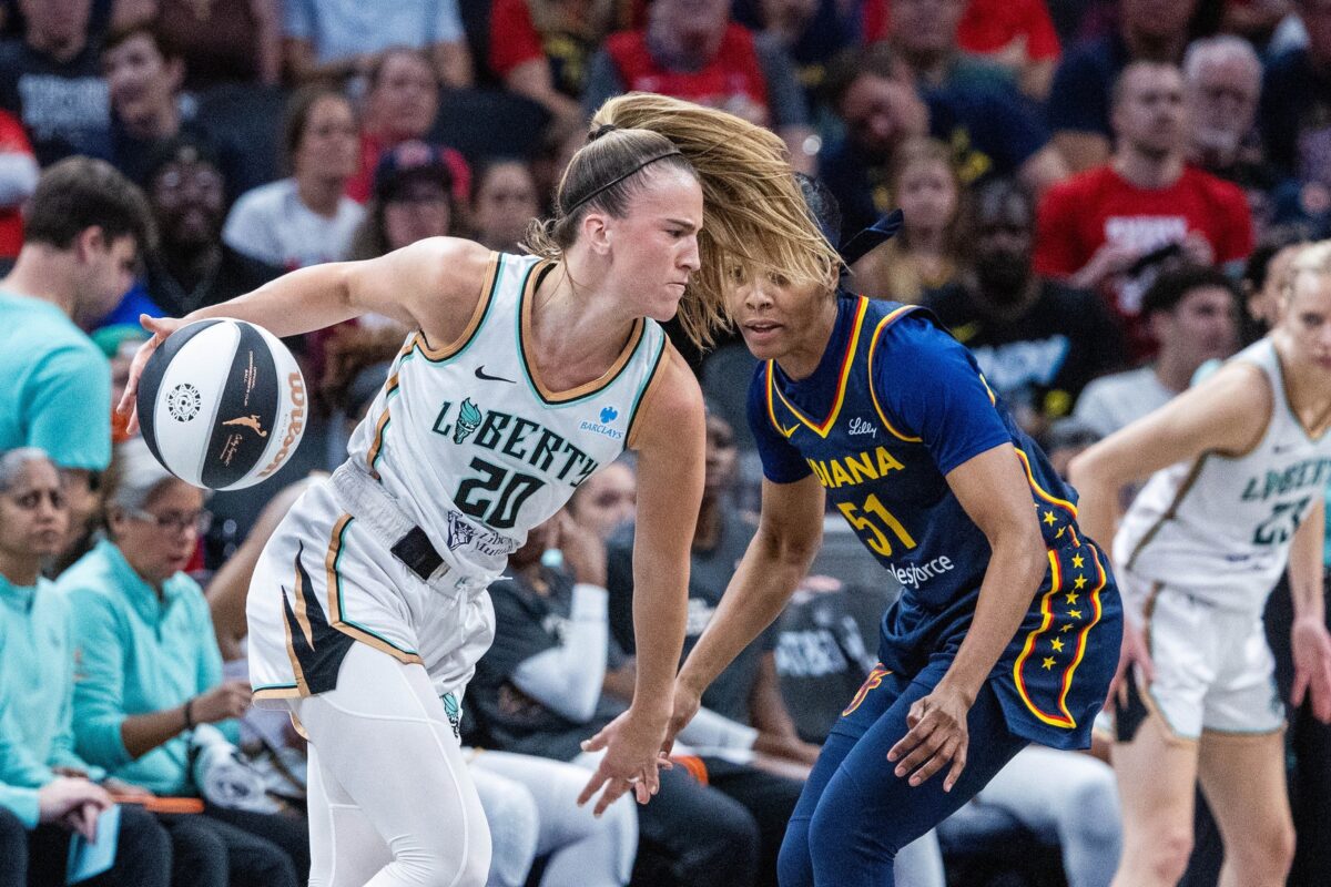 New York Liberty guard wearing No. 20 drives with the ball against an Indiana Fever defender during 2026 WNBA action