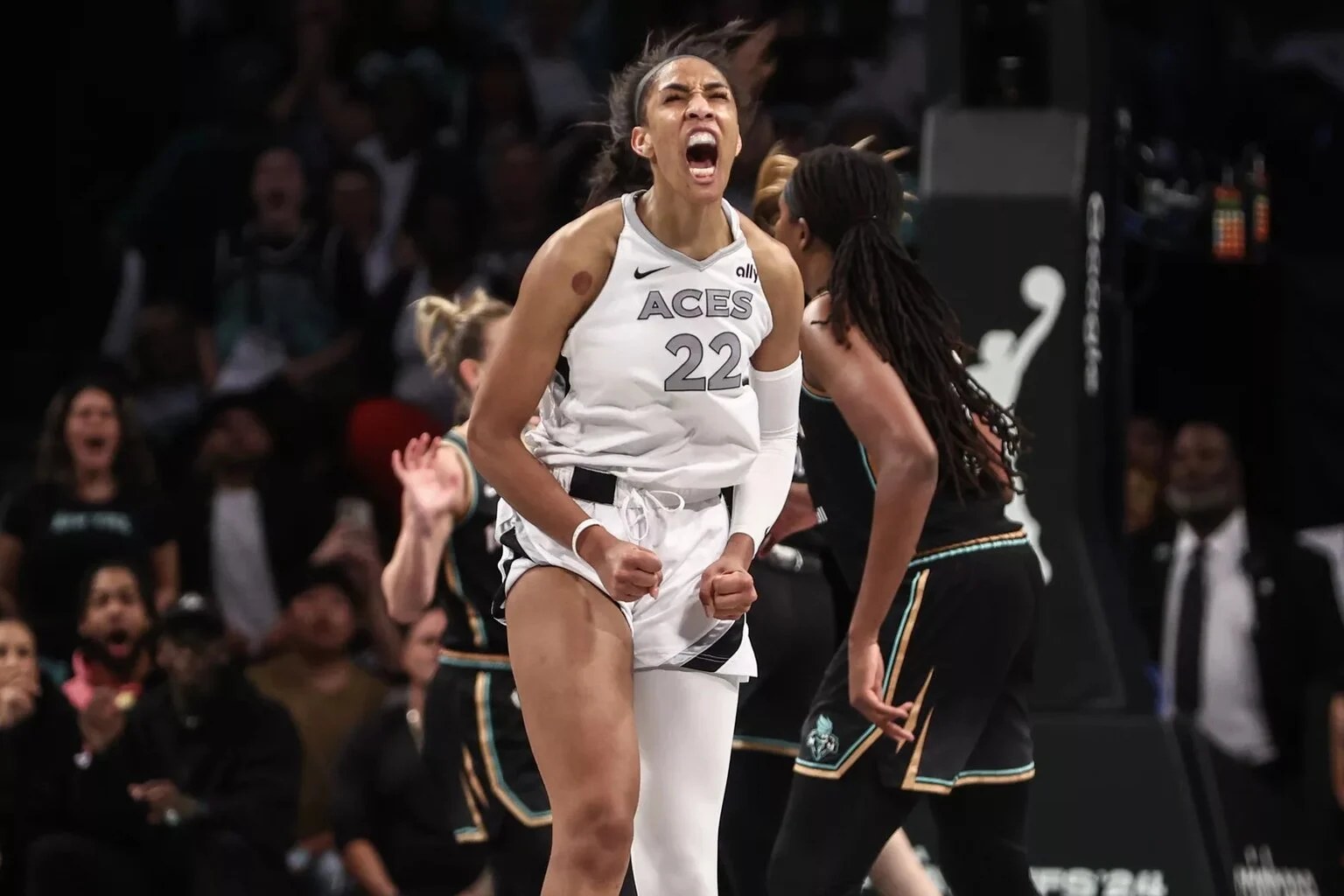 Las Vegas Aces star A'ja Wilson celebrating in the white home uniform.