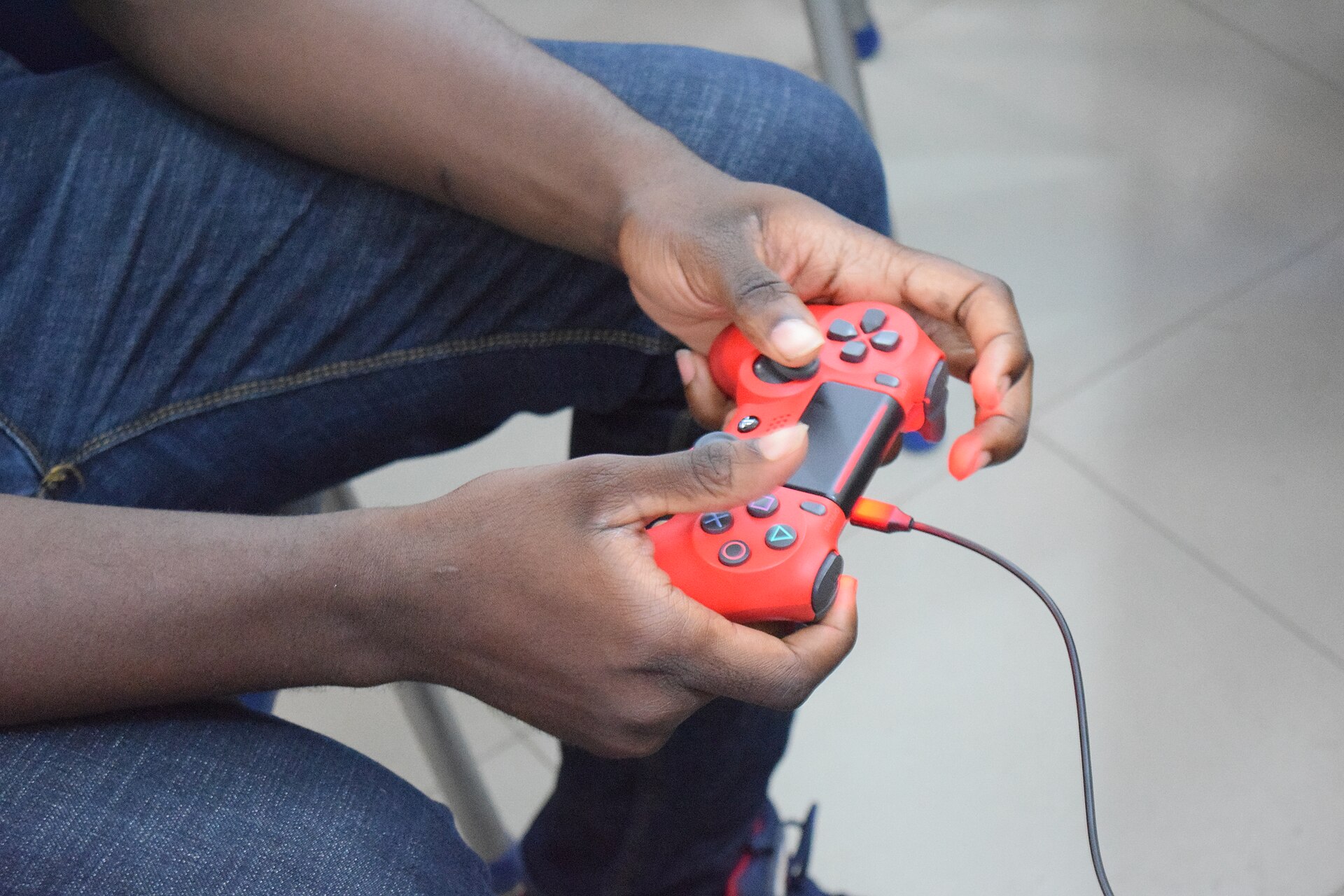 A player holding a controller in front of a screen (file photo)