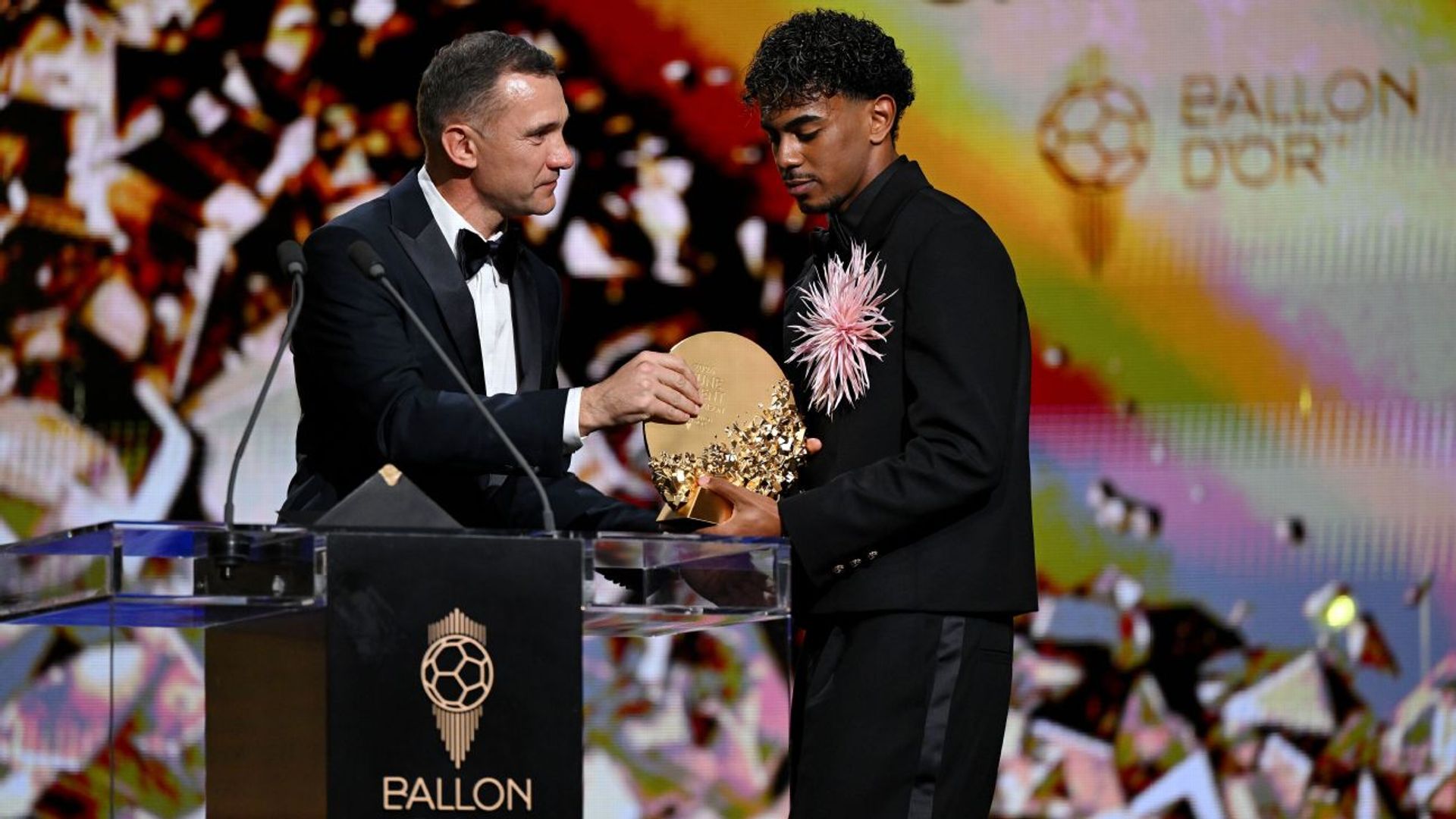 Lamine Yamal receives the Kopa Trophy from Andriy Shevchenko at the Ballon d'Or ceremony at the London Palladium