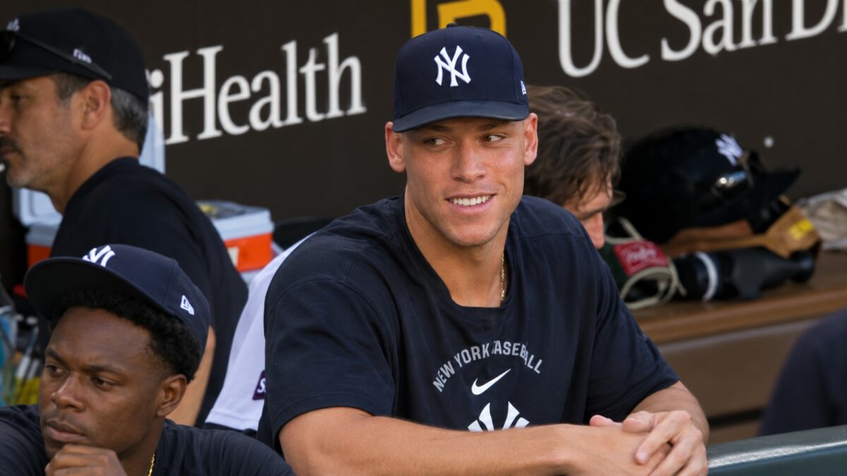 Aaron Judge in the Yankees dugout — out of the ALDS with a right calf strain
