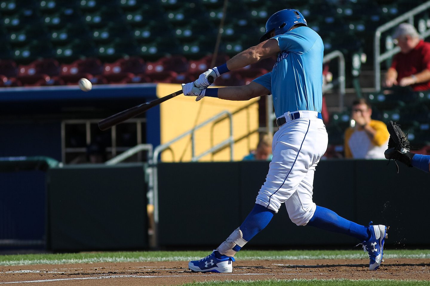 Baseball batter mid-swing in daylight