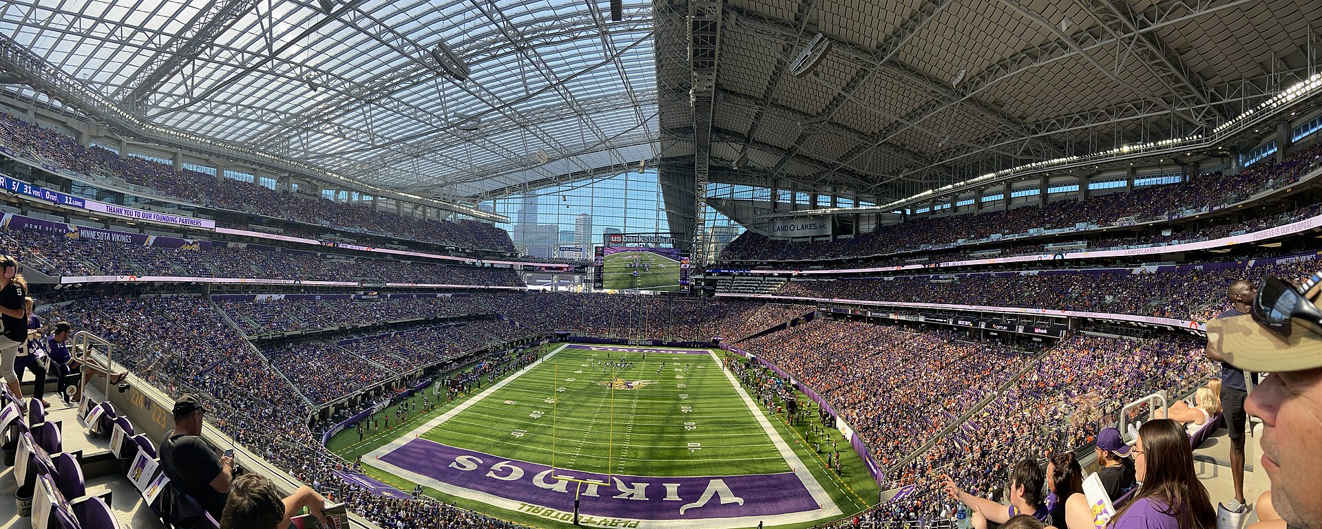 A packed NFL stadium on a bright game day