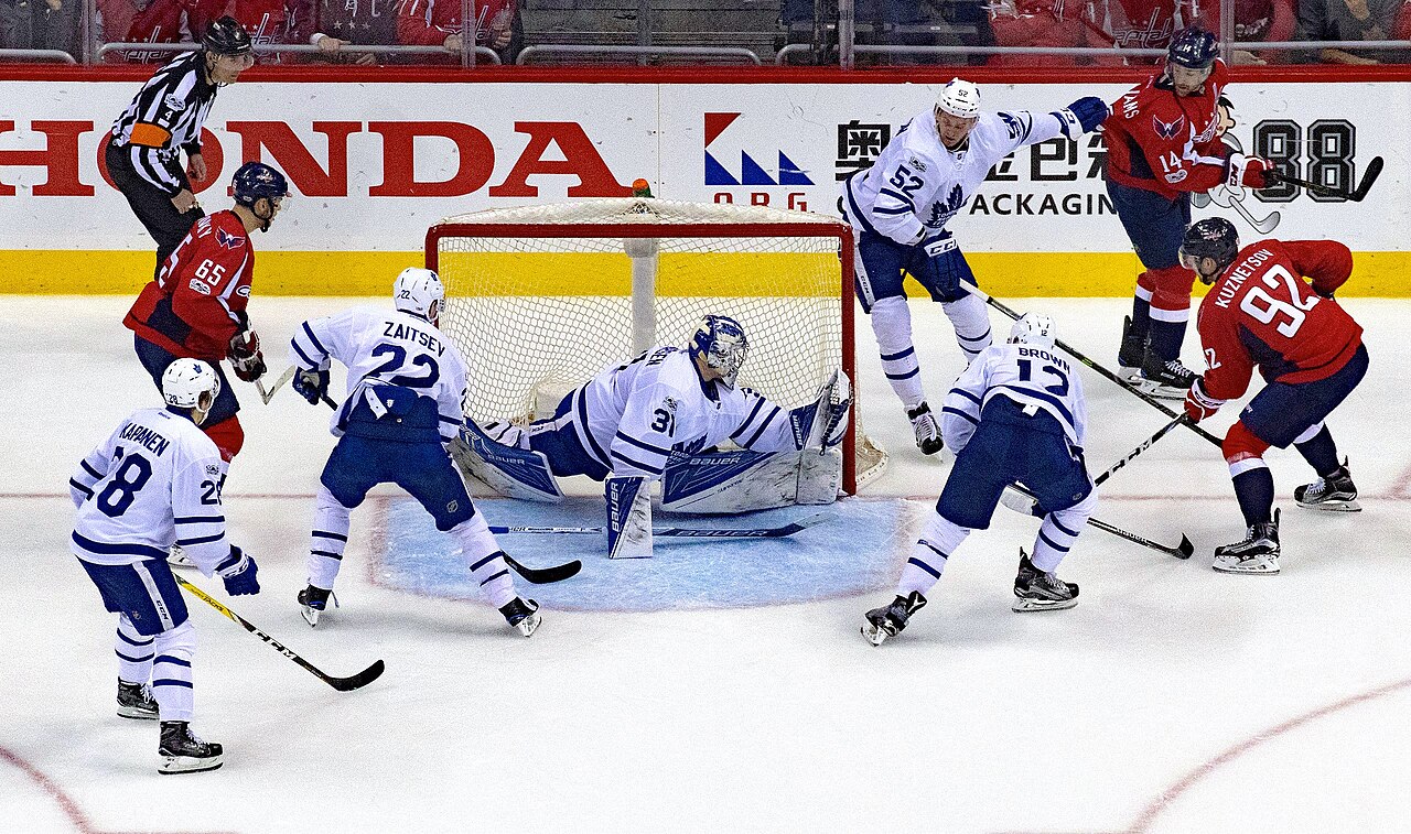 NHL game action — players battle in front of the net